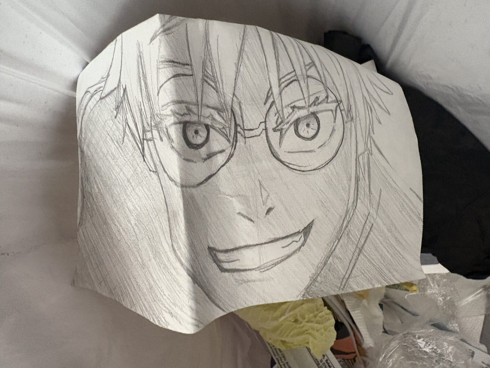 Pencil sketch of a smiling face wearing glasses